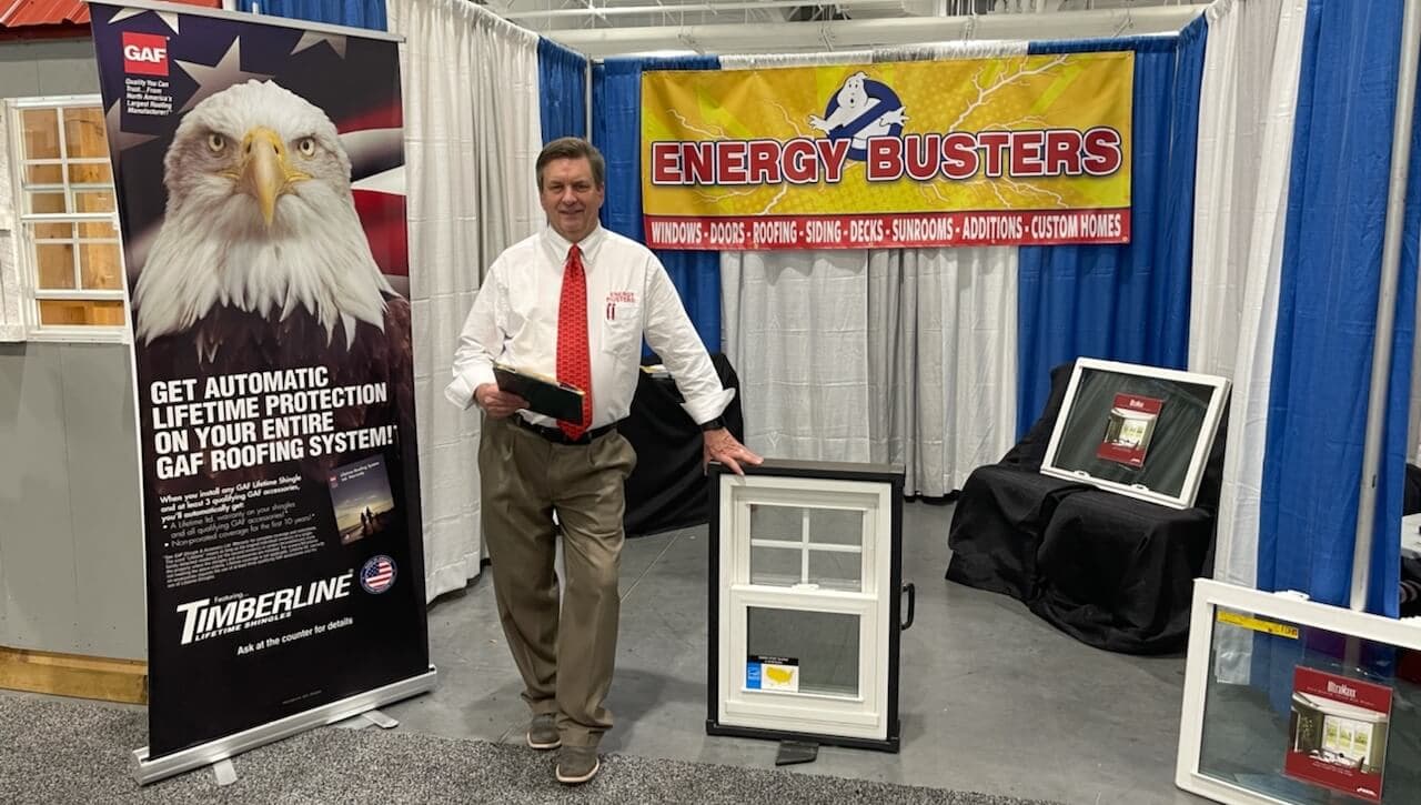 Energy Busters booth at home show with GAF roofing and window displays